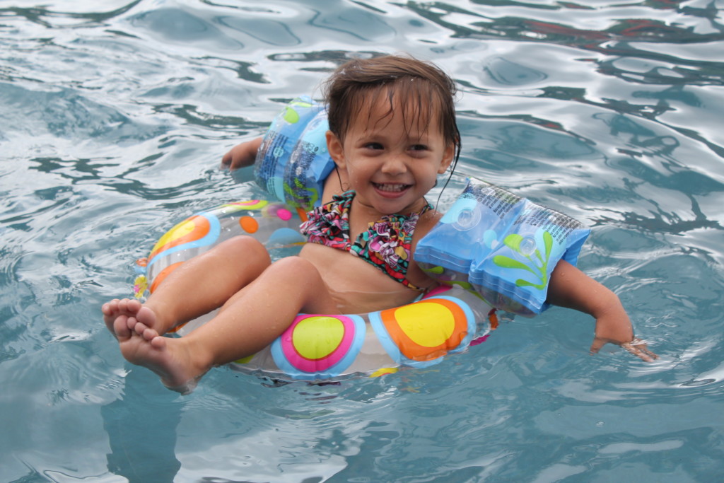 toddler in pool tube